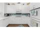 White kitchen with teal backsplash and stainless steel appliances at 11100 Hacienda Del Mar Blvd # 202, Placida, FL 33946