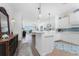 White kitchen with island and teal backsplash at 11100 Hacienda Del Mar Blvd # 202, Placida, FL 33946