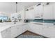 White kitchen with stainless steel appliances and a tile backsplash at 11100 Hacienda Del Mar Blvd # 202, Placida, FL 33946