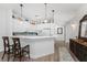 Kitchen with white cabinets, breakfast bar and wood floors at 11100 Hacienda Del Mar Blvd # 202, Placida, FL 33946