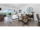 Casual dining area with a glass-top table and wicker chairs, hardwood floors, and living room view at 11100 Hacienda Del Mar Blvd # 202, Placida, FL 33946