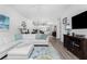 Bright living room with white sectional sofa, wood-look floors, and adjacent kitchen area at 11100 Hacienda Del Mar Blvd # 202, Placida, FL 33946