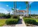 Resort-style community pool surrounded by lush landscaping and palm trees at 11100 Hacienda Del Mar Blvd # 202, Placida, FL 33946