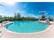 Large kidney-shaped swimming pool with surrounding patio and lounge chairs at 11100 Hacienda Del Mar Blvd # 202, Placida, FL 33946