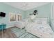 Guest bedroom with two twin beds, light wood floors, and coastal decor at 11100 Hacienda Del Mar Blvd # 202, Placida, FL 33946