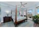 Spacious bedroom with a post bed, water view, and ceiling fan at 11100 Hacienda Del Mar Blvd # 202, Placida, FL 33946