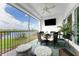 Relax on this screened balcony boasting water views, comfy seating, and a ceiling fan at 11100 Hacienda Del Mar Blvd # 202, Placida, FL 33946