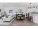 Living room with white sectional sofa and adjacent kitchen at 11100 Hacienda Del Mar Blvd # 202, Placida, FL 33946
