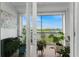 Screened lanai with water views and lush tropical plants at 11100 Hacienda Del Mar Blvd # 202, Placida, FL 33946