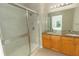 Bathroom with double vanity, granite countertop and shower at 8403 Placida Rd # 303, Placida, FL 33946