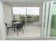 Private balcony with table and chairs overlooking a pond at 8403 Placida Rd # 303, Placida, FL 33946
