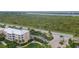 Aerial view of condo building near water at 8403 Placida Rd # 303, Placida, FL 33946