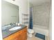 Bathroom with single vanity, tub shower combo and shelving at 8403 Placida Rd # 303, Placida, FL 33946