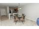 Bright dining area with glass table and four chairs, adjacent to kitchen at 8403 Placida Rd # 303, Placida, FL 33946
