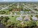 Aerial view showcasing a neighborhood with houses and lush green landscape at 7506 Spinnaker Blvd, Englewood, FL 34224