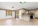 Kitchen features white cabinets, tile floors, and a breakfast bar at 7506 Spinnaker Blvd, Englewood, FL 34224