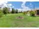 Spacious backyard with fire pit and large grassy area at 7506 Spinnaker Blvd, Englewood, FL 34224
