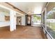 Bright screened porch with ceiling fans and sliding glass doors at 7506 Spinnaker Blvd, Englewood, FL 34224
