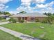 Single-story home with a peach-colored facade and a spacious lawn at 7506 Spinnaker Blvd, Englewood, FL 34224