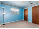 Blue bedroom with carpet, ceiling fan, and window at 7506 Spinnaker Blvd, Englewood, FL 34224
