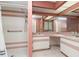 Bathroom with dual sinks, shower, and updated vanity at 7506 Spinnaker Blvd, Englewood, FL 34224