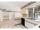 Kitchen with white cabinets, tile backsplash, and stainless steel appliances at 7506 Spinnaker Blvd, Englewood, FL 34224