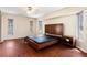 Main bedroom with wood floors, large bed, and ample natural light at 7506 Spinnaker Blvd, Englewood, FL 34224