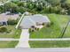 Single-story home with gray roof, spacious yard, and driveway at 7506 Spinnaker Blvd, Englewood, FL 34224