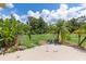 Large backyard with grassy area, tropical plants and patio at 7506 Spinnaker Blvd, Englewood, FL 34224