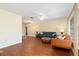 Living room with hardwood floors, teal and orange couches at 7506 Spinnaker Blvd, Englewood, FL 34224