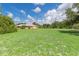 Property with expansive lawn and mature trees at 7506 Spinnaker Blvd, Englewood, FL 34224