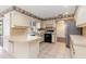 Kitchen with white cabinets, tile floors, and a breakfast bar at 7506 Spinnaker Blvd, Englewood, FL 34224