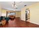 Living room with hardwood floors, view to kitchen, and lots of natural light at 7506 Spinnaker Blvd, Englewood, FL 34224
