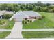 One-story home with a gray roof, and a large front yard at 7506 Spinnaker Blvd, Englewood, FL 34224