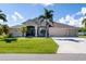 Single-Gathering home with three-car garage and palm trees at 15507 Aqua Cir, Port Charlotte, FL 33981