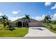 Single-Gathering home with three-car garage and palm trees at 15507 Aqua Cir, Port Charlotte, FL 33981