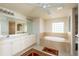 Elegant bathroom with double vanity, soaking tub, and walk-in shower at 15507 Aqua Cir, Port Charlotte, FL 33981