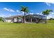 House with a screened pool and patio in a large backyard at 15507 Aqua Cir, Port Charlotte, FL 33981