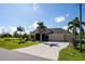 Single-Gathering home with three-car garage and palm trees at 15507 Aqua Cir, Port Charlotte, FL 33981