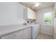 Bright laundry room with washer, dryer and cabinets at 15507 Aqua Cir, Port Charlotte, FL 33981