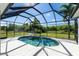 Inviting screened pool with lush landscaping at 15507 Aqua Cir, Port Charlotte, FL 33981