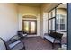 Front porch with wicker furniture and double wood doors at 15507 Aqua Cir, Port Charlotte, FL 33981