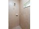 Walk-in shower with neutral tile and window at 15507 Aqua Cir, Port Charlotte, FL 33981