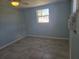 Light blue walls, grey tile floors, and a window with a view at 317 E Green St, Englewood, FL 34223