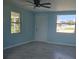 Living room with light blue walls, gray tile floors, and ceiling fan at 317 E Green St, Englewood, FL 34223