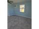 Living room with light blue walls and gray tile floors at 317 E Green St, Englewood, FL 34223