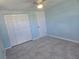 Bedroom with double-door closet, light blue walls and grey tile floors at 317 E Green St, Englewood, FL 34223