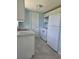 Efficient kitchen featuring white cabinets and grey tile floors at 317 E Green St, Englewood, FL 34223