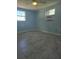 Spacious bedroom with light blue walls, ceiling fan, and grey tile floors at 317 E Green St, Englewood, FL 34223