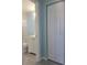 Clean bathroom with white vanity, toilet, and grey tile floors at 317 E Green St, Englewood, FL 34223